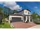 Two-story home with a dark gray garage door at 5443 Carrara Ct, St Cloud, FL 34771