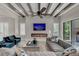 Living room features a fireplace, large TV, and access to backyard patio at 1110 Watson Ct, Reunion, FL 34747