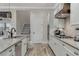 Modern kitchen with white cabinets, stainless steel appliances, and large island at 1110 Watson Ct, Reunion, FL 34747