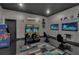 Game room boasts classic arcade games and modern gaming setup at 1110 Watson Ct, Reunion, FL 34747