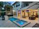Stunning backyard with pool, spa, outdoor kitchen, and entertainment area at 1110 Watson Ct, Reunion, FL 34747