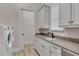 Bright laundry room with washer, dryer, and ample counter space at 1110 Watson Ct, Reunion, FL 34747