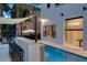 Outdoor pool area with a bar and a projector screen at 1110 Watson Ct, Reunion, FL 34747