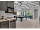 Wet bar with mini-fridge and sink, located near game room at 1110 Watson Ct, Reunion, FL 34747