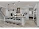 Modern kitchen with white cabinets, stainless steel appliances, and breakfast bar at 1110 Watson Ct, Reunion, FL 34747