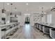 Modern kitchen boasts a large island with seating, stainless steel appliances, and ample counter space at 1110 Watson Ct, Reunion, FL 34747