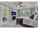 Spacious main bedroom with private balcony access and a large TV at 1110 Watson Ct, Reunion, FL 34747