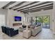 Spacious living room with fireplace, large TV, and sliding doors to backyard at 1110 Watson Ct, Reunion, FL 34747