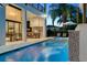 Backyard oasis featuring a pool, spa, and outdoor kitchen at 1110 Watson Ct, Reunion, FL 34747