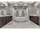 Spa-like bathroom with double vanities, large shower, and a free-standing tub at 1110 Watson Ct, Reunion, FL 34747