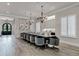 Elegant dining room features a large table with seating for twelve and a stunning chandelier at 1110 Watson Ct, Reunion, FL 34747