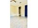 Bright bedroom with tile floors, ceiling fan, and ensuite bathroom at 125 Grand Junction Blvd, Orlando, FL 32835