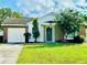 Charming one-story house with a brick facade and well-manicured lawn at 125 Grand Junction Blvd, Orlando, FL 32835