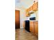 Kitchen with wood cabinets, black appliances, and tile floors at 125 Grand Junction Blvd, Orlando, FL 32835