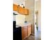 Kitchen with wood cabinets and a view of the bathroom at 125 Grand Junction Blvd, Orlando, FL 32835