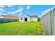 Large backyard with green grass and wooden fence at 125 Grand Junction Blvd, Orlando, FL 32835