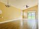 Living room with tile floors, a ceiling fan and sliding glass doors to backyard at 125 Grand Junction Blvd, Orlando, FL 32835