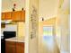 Kitchen with wood cabinets and a view into the living room at 125 Grand Junction Blvd, Orlando, FL 32835