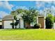 Brick house with a white front door and a well-maintained lawn at 125 Grand Junction Blvd, Orlando, FL 32835
