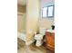 Simple bathroom with tub, toilet, and wood vanity at 125 Grand Junction Blvd, Orlando, FL 32835