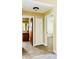 Bright hallway with tile floors, linen closet, and views of bathroom and bedroom at 125 Grand Junction Blvd, Orlando, FL 32835