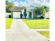 House with a driveway and a nicely landscaped front yard at 125 Grand Junction Blvd, Orlando, FL 32835