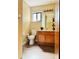 Clean bathroom with wood vanity, toilet, and tile floor at 125 Grand Junction Blvd, Orlando, FL 32835
