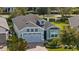 Single-story house with gray garage and light-blue exterior. Landscaped yard and brick driveway at 2160 Antilles Club Dr, Kissimmee, FL 34747