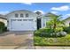 Single-story home with two-car garage and landscaping at 2160 Antilles Club Dr, Kissimmee, FL 34747