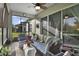 Cozy screened-in porch with seating and ceiling fan at 2160 Antilles Club Dr, Kissimmee, FL 34747