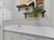 Laundry room with utility sink and wooden shelves at 2160 Antilles Club Dr, Kissimmee, FL 34747