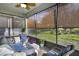 Relaxing screened porch with wicker furniture and lush landscaping views at 2160 Antilles Club Dr, Kissimmee, FL 34747