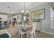Bright dining room with white chairs and farmhouse style table at 2160 Antilles Club Dr, Kissimmee, FL 34747
