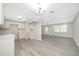Open floor plan showcasing a modern kitchen and spacious living area at 3703 Wade Rd, Orlando, FL 32808