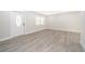 Bright living room featuring new laminate flooring and fresh paint at 3703 Wade Rd, Orlando, FL 32808