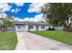 Newly renovated single story home with a grassy yard at 3703 Wade Rd, Orlando, FL 32808