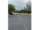 Asphalt road with mature trees and parked car at 4229 S Lake Orlando Pkwy # 133, Orlando, FL 32808