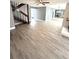Open living room with wood-look floors and fireplace at 4229 S Lake Orlando Pkwy # 133, Orlando, FL 32808
