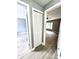 Bright hallway with wood-look floors and white louvered doors at 4229 S Lake Orlando Pkwy # 133, Orlando, FL 32808