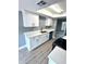 Modern kitchen boasts white cabinets and teal appliances at 4229 S Lake Orlando Pkwy # 133, Orlando, FL 32808