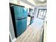 Modern kitchen features teal appliances and wood-look flooring at 4229 S Lake Orlando Pkwy # 133, Orlando, FL 32808