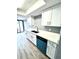 Modern kitchen with white cabinets, quartz countertops, and teal appliances at 4229 S Lake Orlando Pkwy # 133, Orlando, FL 32808