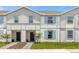 Two-story townhome with light-colored siding and a landscaped yard at 4306 Lana Ave, Davenport, FL 33897