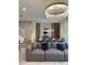 Spacious living room showcasing a large sectional sofa and elegant chandelier at 4306 Lana Ave, Davenport, FL 33897
