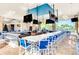 L-shaped indoor pool bar with multiple TVs and blue and white seating at 4306 Lana Ave, Davenport, FL 33897