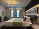 Main bedroom boasts a king bed, stylish chair, and modern decor at 4306 Lana Ave, Davenport, FL 33897