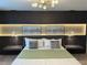 Main bedroom with a king-size bed and a wood slat accent wall with integrated lighting at 4306 Lana Ave, Davenport, FL 33897