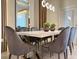 Elegant dining area with a contemporary table and plush velvet chairs at 4306 Lana Ave, Davenport, FL 33897