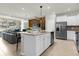 Open kitchen with island, stainless steel appliances, and granite countertops at 4306 Lana Ave, Davenport, FL 33897