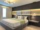 Elegant main bedroom featuring a plush bed and a unique, illuminated wall design at 4306 Lana Ave, Davenport, FL 33897